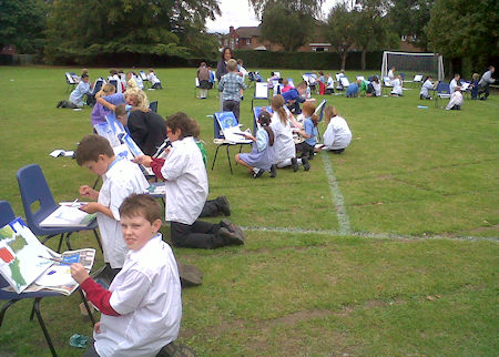 art lesson children painting outside